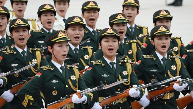 Female soldiers of the Guard of Honour of the People's Liberation Army shout as they walk in front of Chinese President Xi Jinping in 2019. Picture: Getty