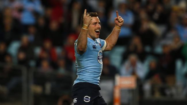 Bernard Foley celebrates after scoring a try for the Waratahs.