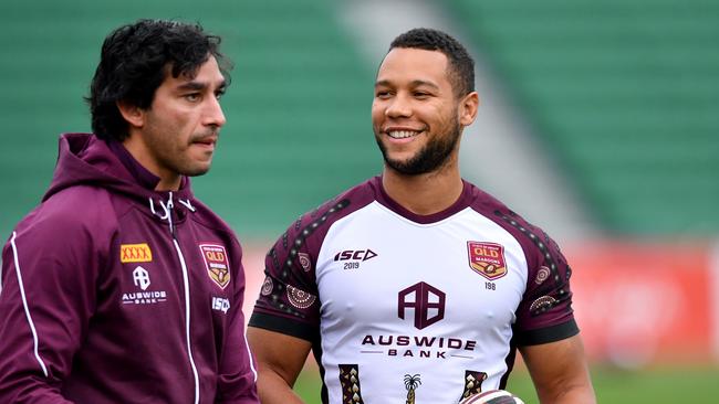 Former Queensland player Johnathan Thurston with Moses Mbye. Picture: AAP Image/Darren England