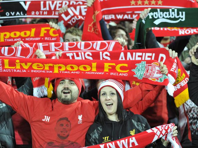 Supporters holding banners cheer ahead of the start of the international friendly football match between Adelaide United and English Premier League side Liverpool in Adelaide on July 20, 2015. AFP PHOTO / David MARIUZ -- IMAGE STRICTLY RESTRICTED TO EDITORIAL USE - STRICTLY NO COMMERCIAL USE