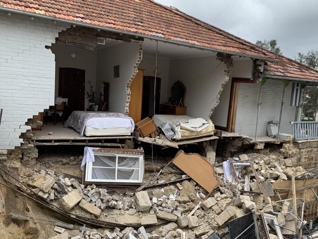 The side of a home collapsed into a neighbouring building site in dramatic scenes at Bondi this afternoon. , Police said the eastern brick wall of the home on Curlewis St went crashing down onto a path and onto a construction sitenext door at around 5.15pm. , MUST CREDIT OnScene Bondi