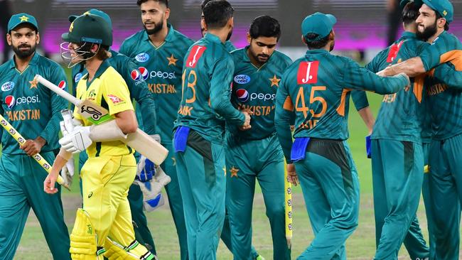 Australian batsman Adam Zampa leaves the pitch as Pakistan players celebrate their win in their third T20 match in Dubai. Picture: AFP