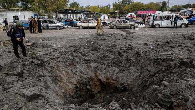 A Ukrainian serviceman looks at a crater left by a missile strike near Zaporizhzhia on September 30. Picture: Kateryna Klochko / AFP