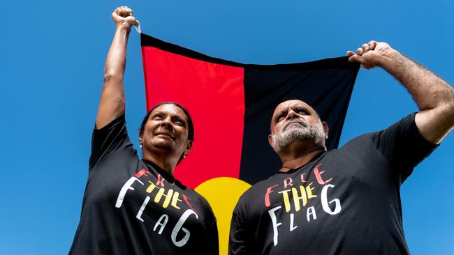 Nova Peris and Michael Long stand with the Aboriginal Flag at Gardens Oval, Darwin ahead of the AFL's Dreamtime Round. Picture: Che Chorley