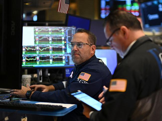 Traders work on the floor of the New York Stock Exchange (NYSE) at the opening bell on November 13, 2024, in New York City. (Photo by ANGELA WEISS / AFP)