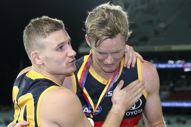 Adelaide’s Rory Laird congratulates Alex Keath after he won the Showdown medal at Adelaide Oval. Picture Sarah Reed