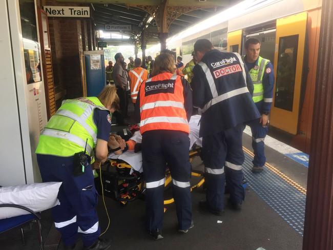 An injured passenger is treated at Richmond Station. Picture: AAP