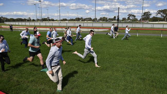 The bet365 Traralgon Cup race meeting was cancelled due to a heavy track, but patrons took matters into their own hands and competed in their own race. Picture: Andrew Batsch