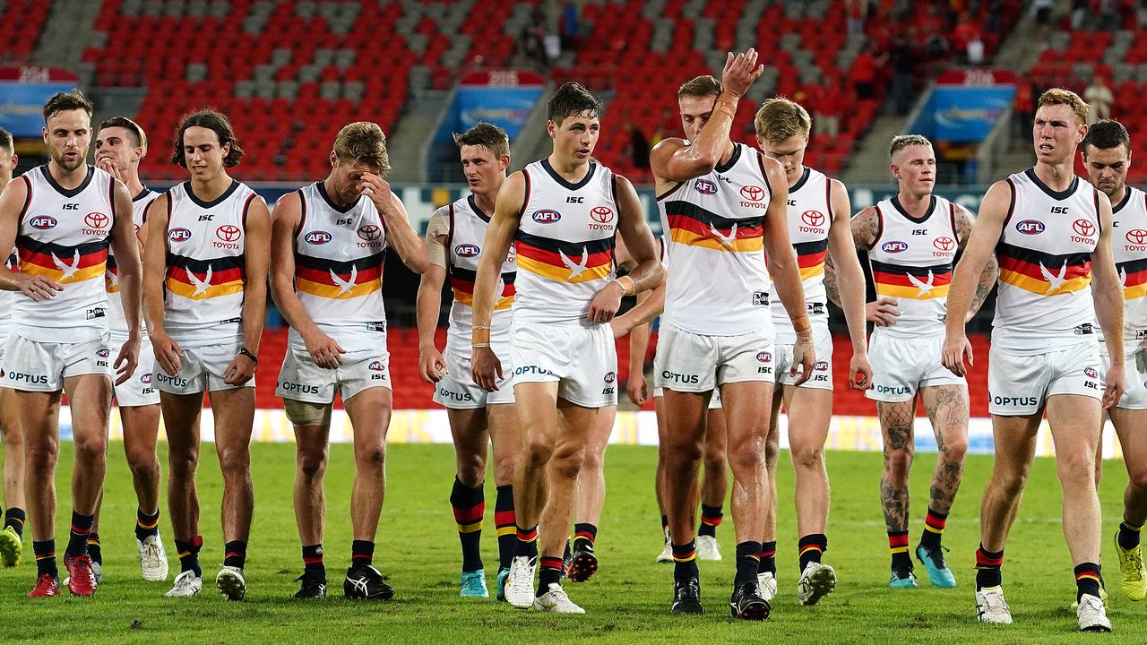 Crows players leave the field following the heavy loss to the Suns. (AAP Image/Dave Hunt)