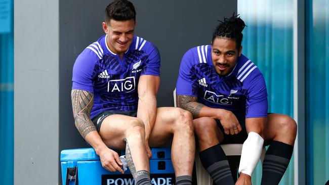 Sonny Bill Williams and Ma’a Nonu of the All Blacks remove their boots following training.