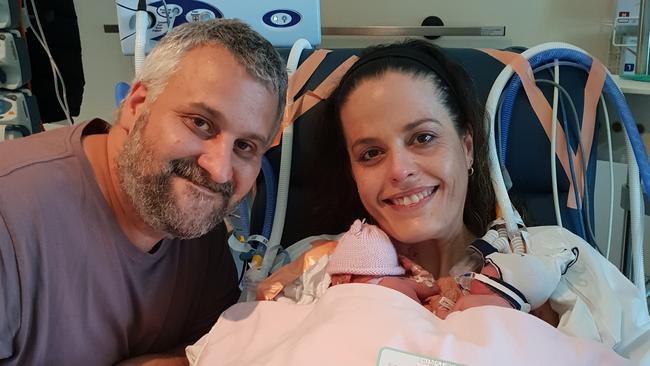 Jim and Francine Adamopoulos cuddle their newborn daughters Mia and Chloe on Mother’s Day last year. 