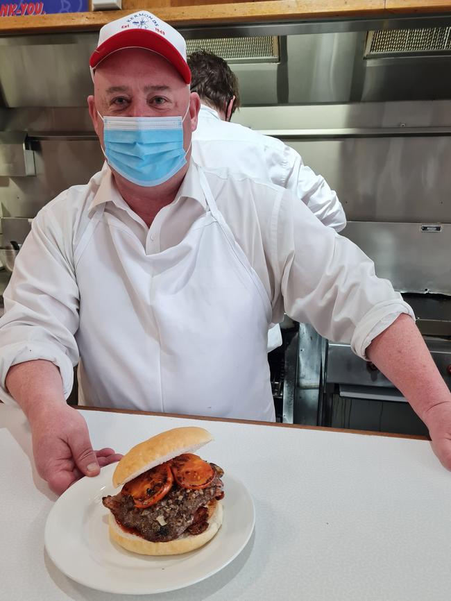 Kermonds Hamburgers in Warrnambool owner Brett Healey with a signature burger – the one with the lot.