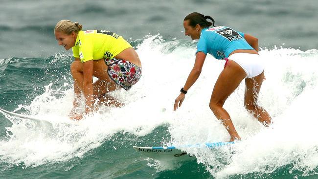 Stephanie Gilmore, left, and Layne Beachley catching a wave together in 2008.