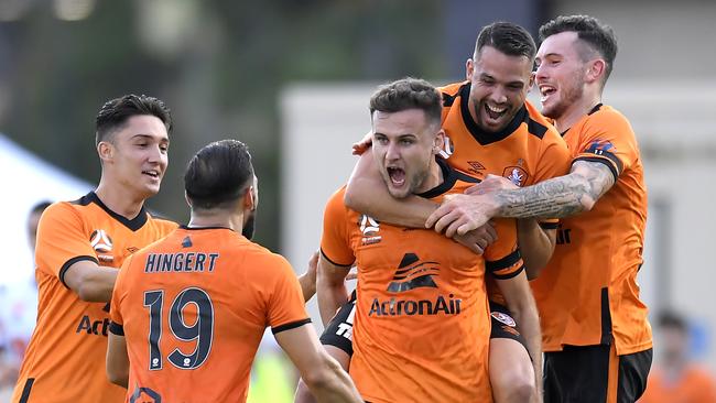 Macaulay Gillesphey is mobbed by his Brisbane Roar teammates. Picture: Albert Perez/Getty Images