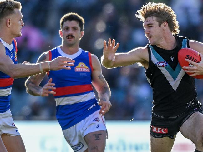 ADELAIDE, AUSTRALIA - JULY 06:  Jason Horne-Francis of the Power fends off   Adam Treloar of the Bulldogs  during the round 17 AFL match between Port Adelaide Power and Western Bulldogs at Adelaide Oval, on July 06, 2024, in Adelaide, Australia. (Photo by Mark Brake/Getty Images)