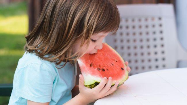 Children love munching on fresh watermelon on a hot day. Image: iStock 