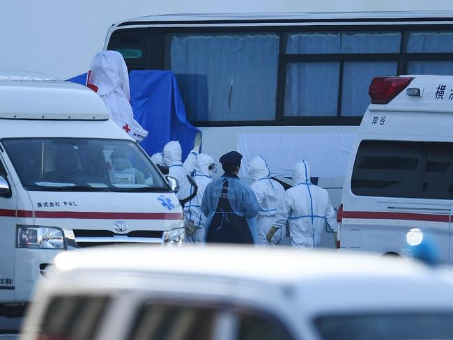 A fleet of ambulances took away 65 people, including four Australians, diagnosed with the coronavirus on board the Diamond Princess. Picture: AFP