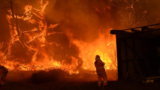 The flames approaches a property in Bilpin. Picture: Jeremy Piper