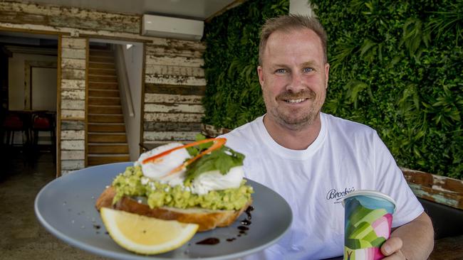 Scott Imlach's new Nobby's brunch spot The Backyard Cafe. Scott holding a smashed Avo dish. Picture: Jerad Williams