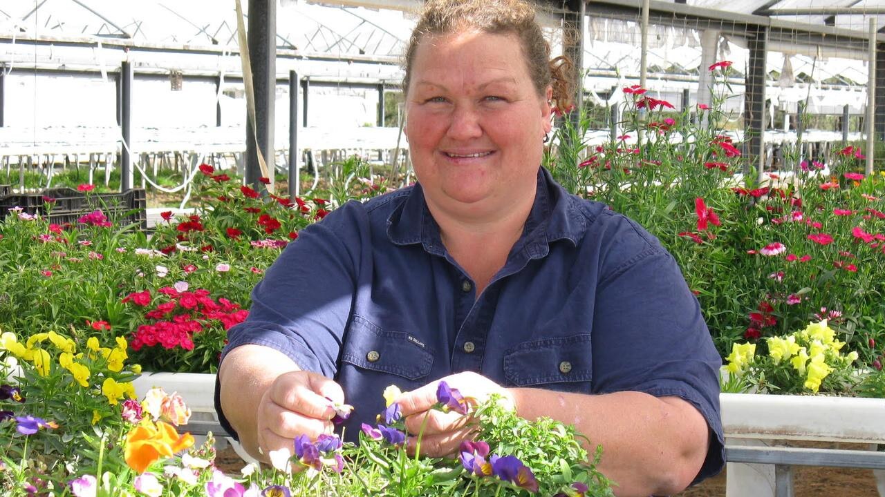 Kym Samuelsen picks edible flowers at Ghost Gully Produce.