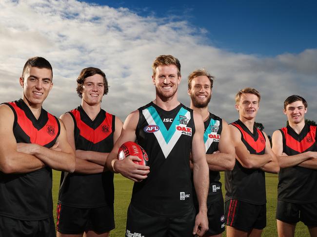 Rostrevor College potential Under 18 State Squad members; footballers L-R Luke Valente, 18yrs, Ben Jarvis, 17yrs, Jacob Kennerley, 17yrs, and Cameron Taheny, 16yrs,  with AFL Port Power players Tom Jonas and Jack Hombsch at the Rostrevor College oval. Picture: DYLAN COKER