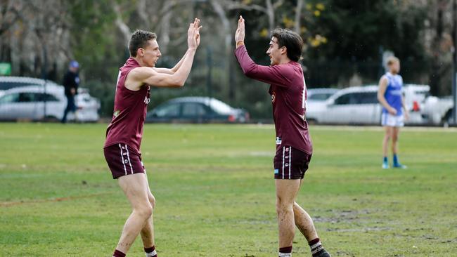 PAOC’s Jake Pitt and Tom Fisher celebrate a goal. Fans tipped the Old Reds to take out the top flight premiership earlier this season. Picture: AAP/Morgan Sette