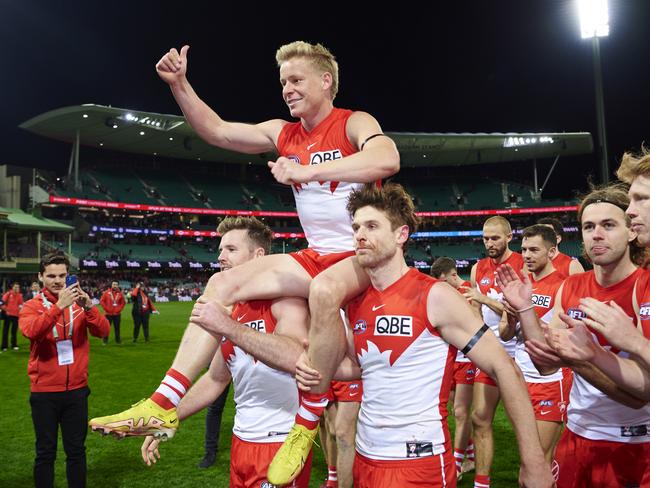 Isaac Heeney of the Swans is carried off the field after victory to celebrate his 150th game during the round 22 AFL match between the Sydney Swans and the Collingwood Magpies at SCG. (Photo by Brett Hemmings/AFL Photos/via Getty Images )