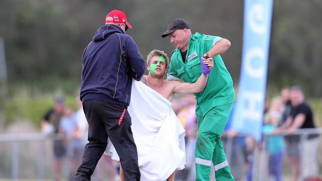 Photos at the Gold Coast and District Rugby Union Grand Final between the Gold Coast Eagles and the Helensvale Hogs (blue) played at Helensvale. Photo of a streaker wearing the Gators mascot's head. He was tackled by a spectator. Photo by Richard Gosling