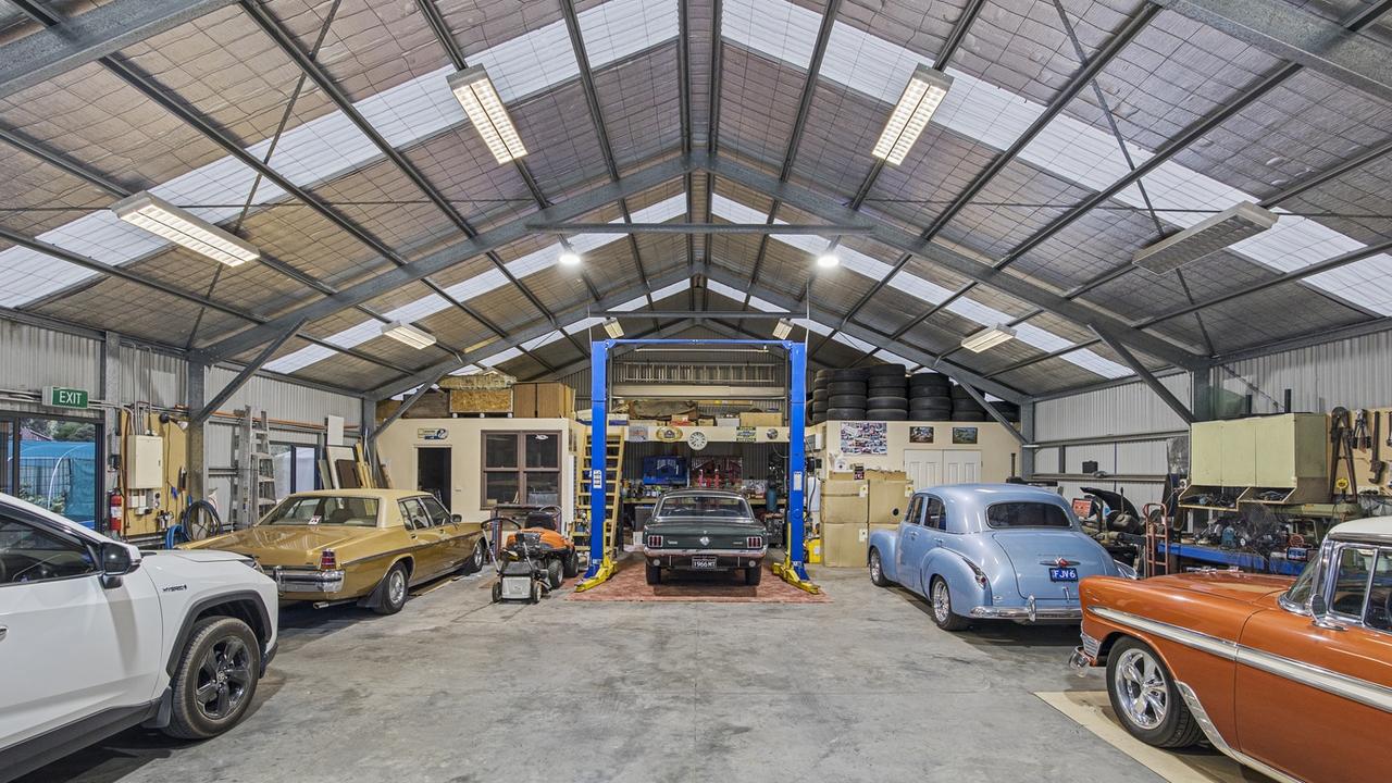 The garage has six vehicles spaces and a hoist.