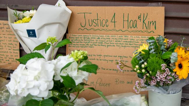 Community members come to lay flowers at the buzzy bee hamburger shop following yesterdays double murder. Picture: Thomas Lisson