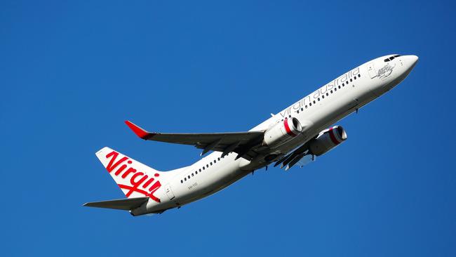 Virgin and Qantas will be selling half price flights from today. Picture: NCA NewsWire / Gaye Gerard