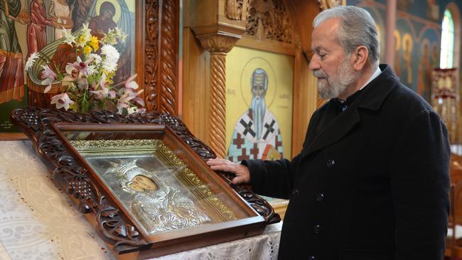 Red Hill Greek Orthodox Church head Fr Eleftevios Tatsis with the religious icon. Picture: Susan Windmiller