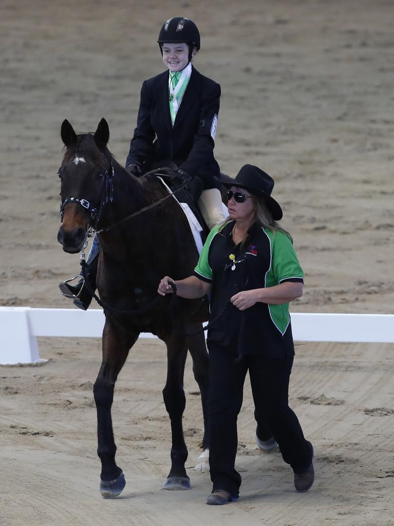 Chantelle Greif riding Rocky the horse during the Walk A (Assisted) competition at the RDAQ 2018 State Championship held at the Queensland State Equestrian Centre, Caboolture, Saturday, July 14, 2018. (AAP Image/Regi Varghese)