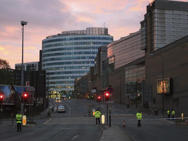 Police stand guard at dawn after a blast at the Manchester Arena. Picture: AP