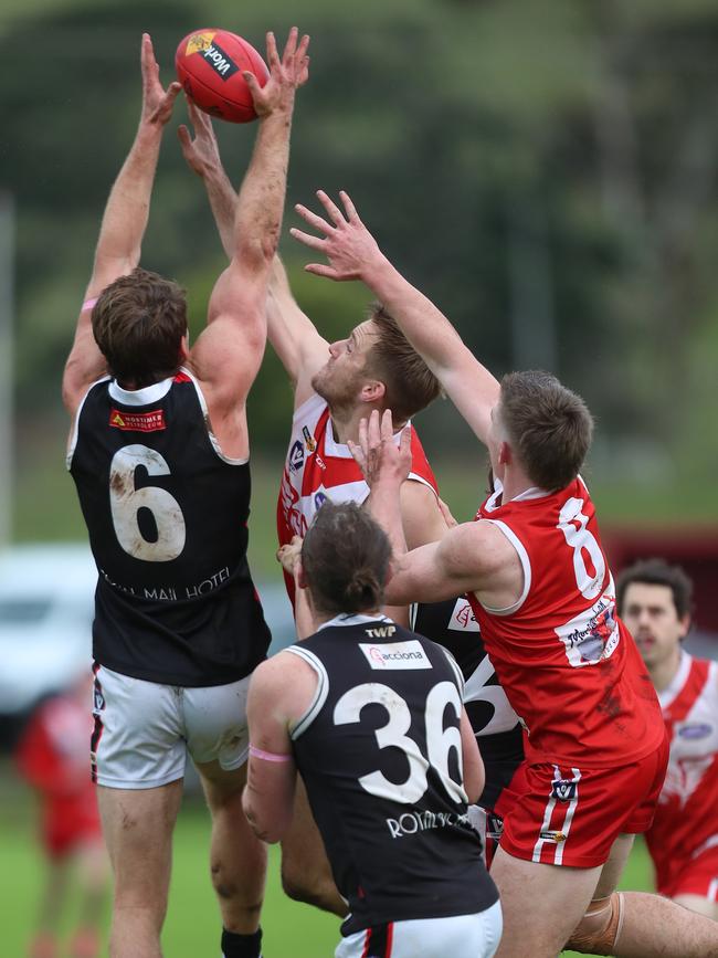 Birregurra’s Oliver Butler takes a strong mark in tough conditions.