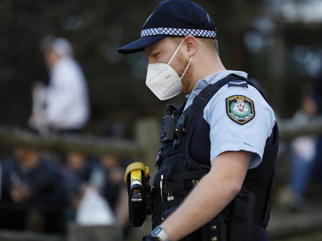 SYDNEY, AUSTRALIA - NewsWire Photos AUGUST 2: Police move on part of a large crowd who had gathered near the grassy knoll at North Bondi, The crowd appeared to be breaking social distancing rules.Picture: NCA NewsWire / Damian Shaw