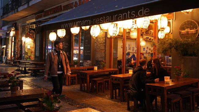 A man walks past restaurants in the Kreuzberg district of Berlin, Germany. Picture: Getty Images