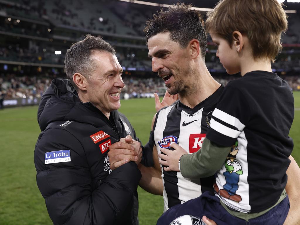 Craig McRae and Scott Pendlebury shake hands a win over Essendon in 2019, with Pendlebury’s family becoming an integral part of the club. Picture: Darrian Traynor/Getty Images.