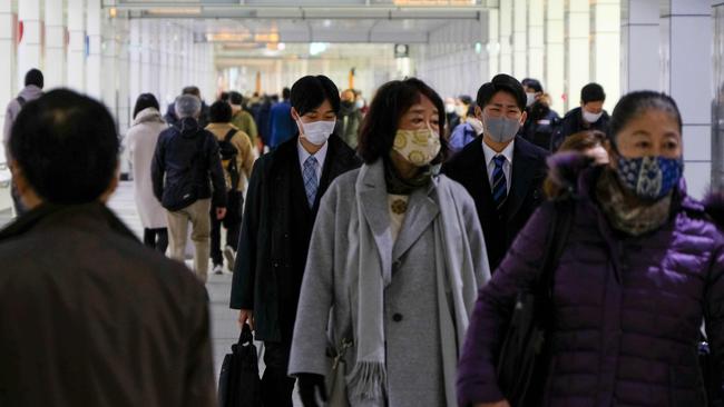 People walk on a concourse leading to the terminal station in Tokyo's Shinjuku district. Picture: AFP