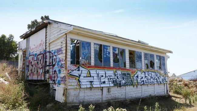 Darko Krajinovic is the owner / developer of 55 Mount Stuart Road and has been charged with the illegal demolition of the original weatherboard house and surrounding garden. Pictured is the site showing graffiti on what is left. Darko is proposing 4 town houses which are before council. Picture: MATT THOMPSON