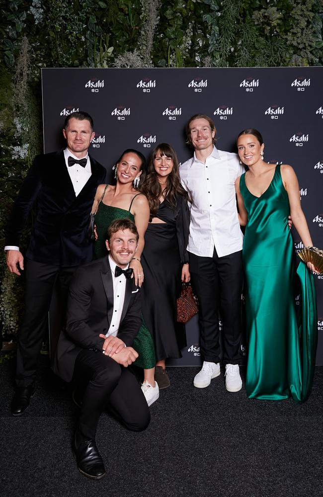 Patrick Dangerfield, Tom Stewart and Tom Atkins with partners at the after-party.