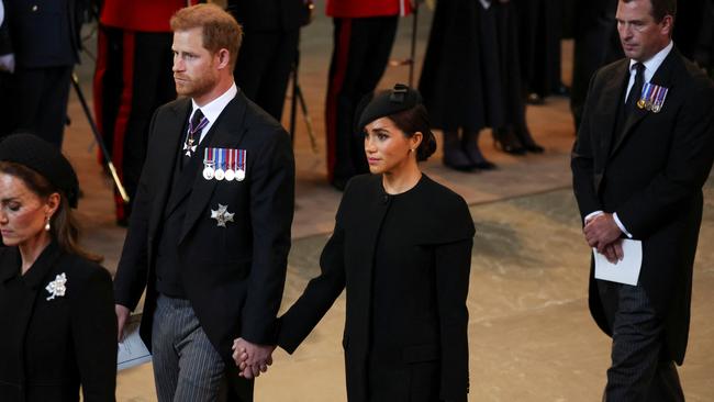 Harry and Meghan have displayed physical affection for each other on several occasions since the Queen died. (Photo by Phil Noble-WPA Pool/Getty Images)