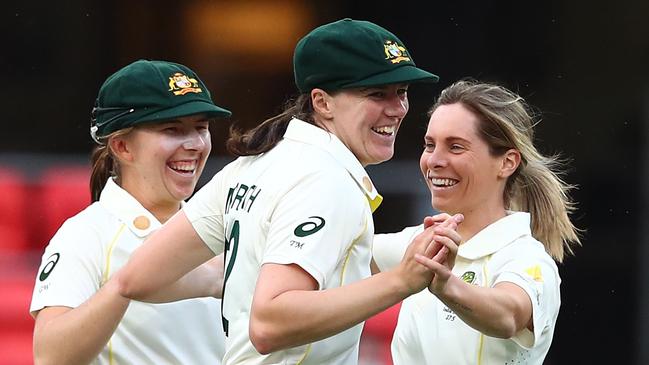 GOLD COAST, AUSTRALIA - SEPTEMBER 30: Sophie Molineux of Australia celebrates with team mates after dismissing Shafali Verma of India during day one of the Women's International Test match between Australia and India at Metricon Stadium on September 30, 2021 in Gold Coast, Australia. (Photo by Chris Hyde/Getty Images)