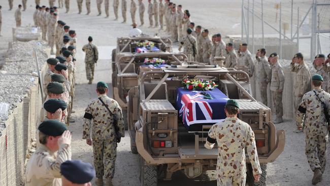 Special Operations Task Group Members and guests attend a memorial service for Pte Benjamin Adam Chuck, Pte Timothy James Aplin and Pte Scott Travis Palmer prior to them being flown home to Australia in 2010.