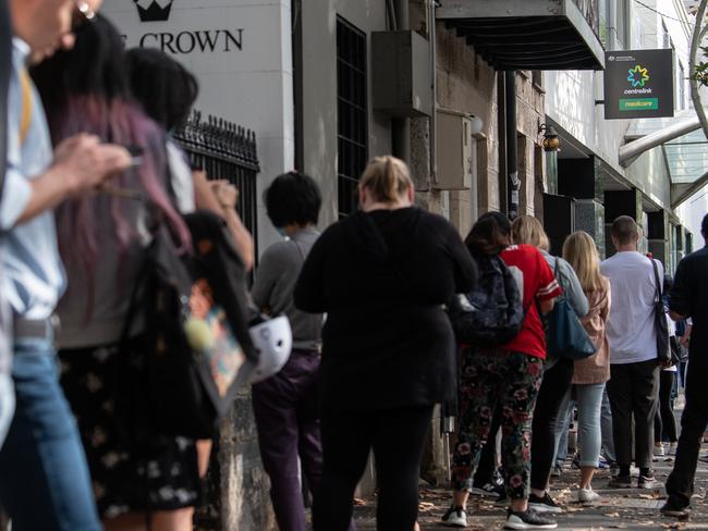 People queue for access to a Centrelink Service Centre in Sydney, Monday, March 23, 2020. The federal government has announced two separate economic stimulus packages, including increased access to Centrelink payments designed to help support the Australian economy through the COVID-19 pandemic. (AAP Image/James Gourley) NO ARCHIVING