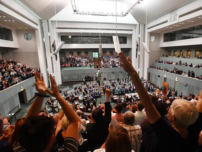 Members celebrate before the passing of the Marriage Amendment Bill. Picture: AAP