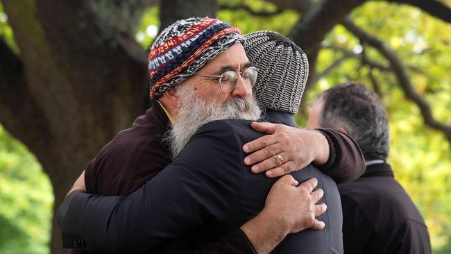 Two New Zealanders comfort each other in Christchurch. Picture: AFP