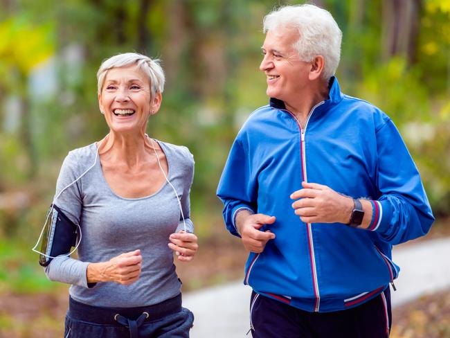 Senior active couple running, walking and talking in the park. Healthy lifestyle