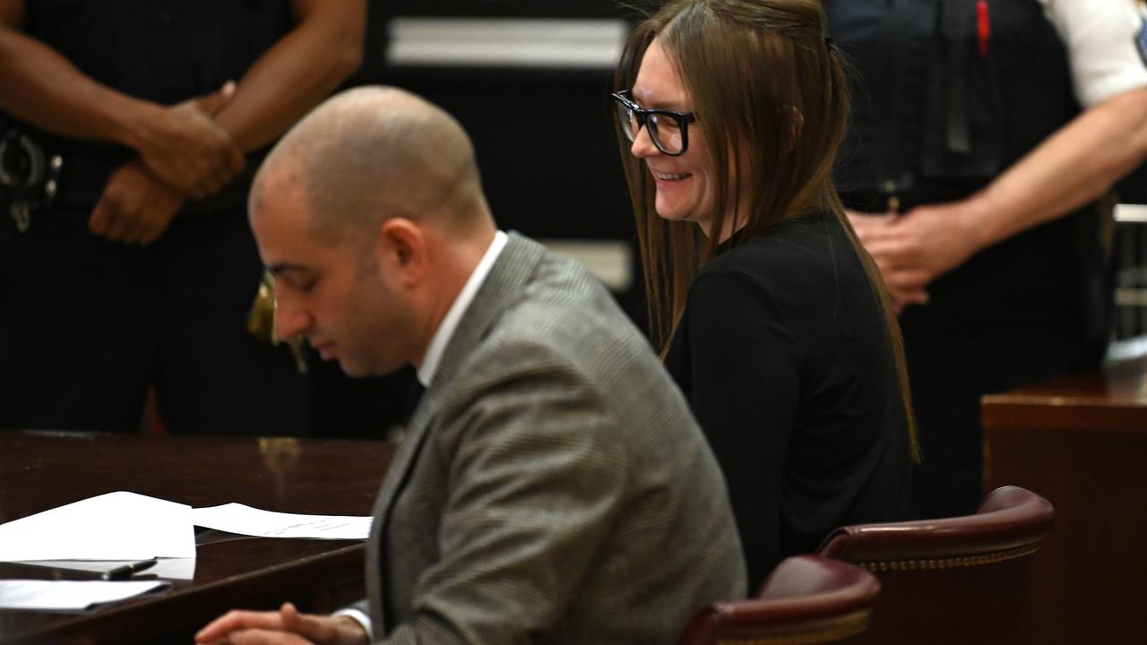 Fake German heiress Anna Sorokin sits smiling next to her lawyer Todd Spodek during her sentencing at Manhattan Supreme Court May 9, 2019. Picture: Timothy A. Clary/AFP