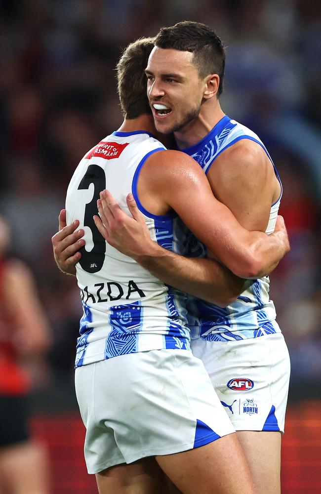 Luke Davies-Uniacke is congratulated by Harry Sheezel after kicking a goal against Essendon. Picture: Quinn Rooney/Getty Images.